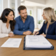 Tampa Bay homebuyers reviewing a fully documented mortgage preapproval with a real estate professional